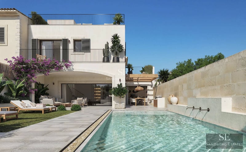 View of infinity pool and lush garden of a modern villa with large windows and minimalist design. Warm sunset glow.