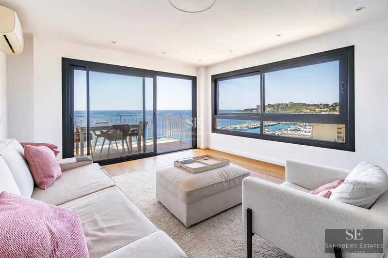 Aerial view of luxurious villa with infinity pool, lush garden, and modern design. Expansive terraces and high-quality finishes.