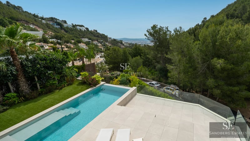 Expansive terrace featuring an infinity pool, sun loungers, and panoramic views. Modern design with clean lines and high-quality materials.