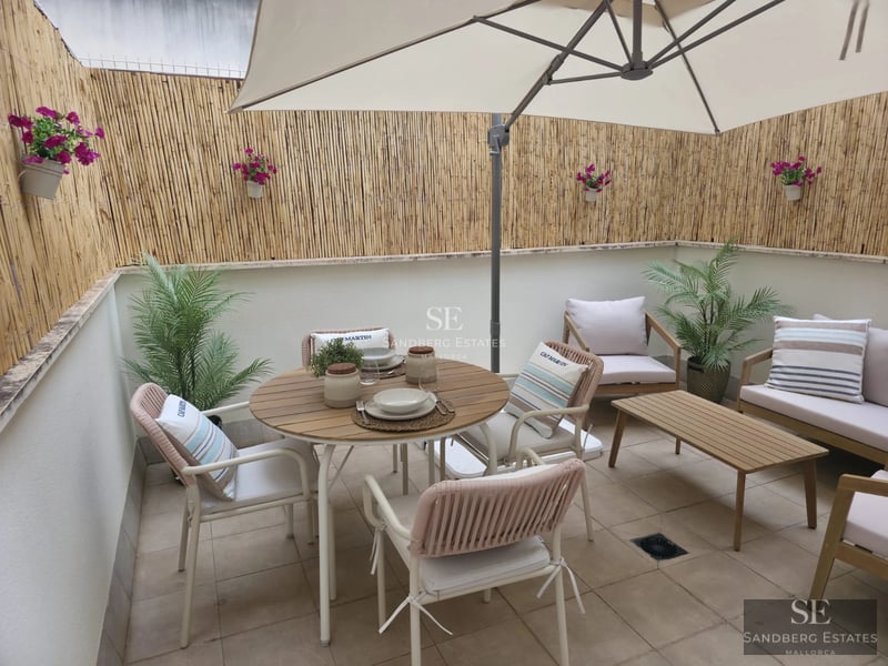 Spacious living room with floor-to-ceiling windows, light wood floors, modern gray sofa, and access to pool terrace. Minimalist, bright design.