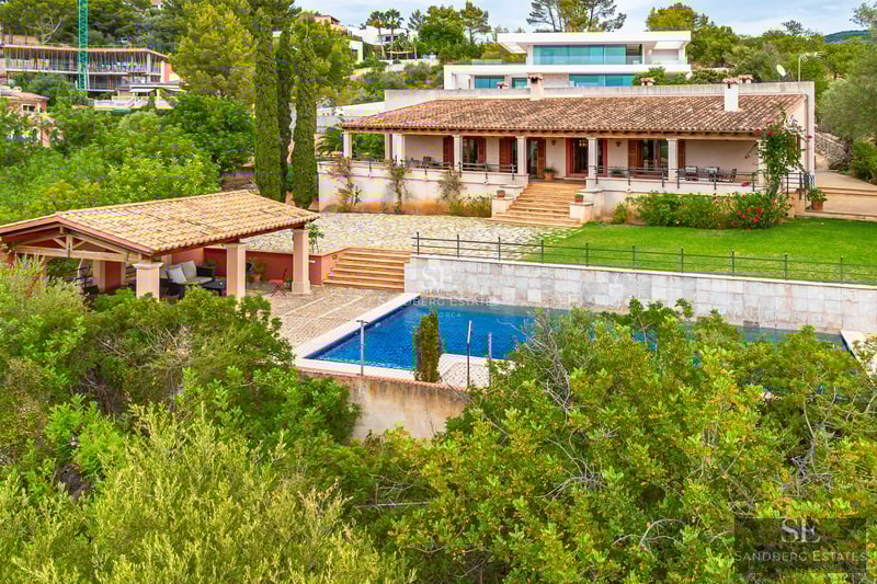Modern exterior featuring an infinity pool, sleek loungers, and lush garden. Minimalist design, clean lines, and expansive views.