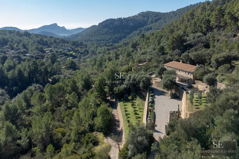 Exterior view of a luxury villa with a pool, manicured garden, and modern architecture. Minimalist design and large window panes.
