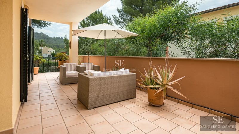 Aerial view of modern villa featuring infinity pool, spacious terraces, minimalist design, and lush gardens. High-quality finishes.
