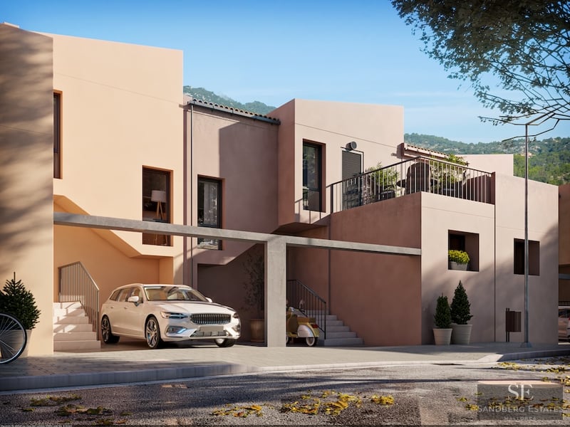 Modern multi-level home with peach-colored walls, a covered parking area with a white car, and architectural stairs.