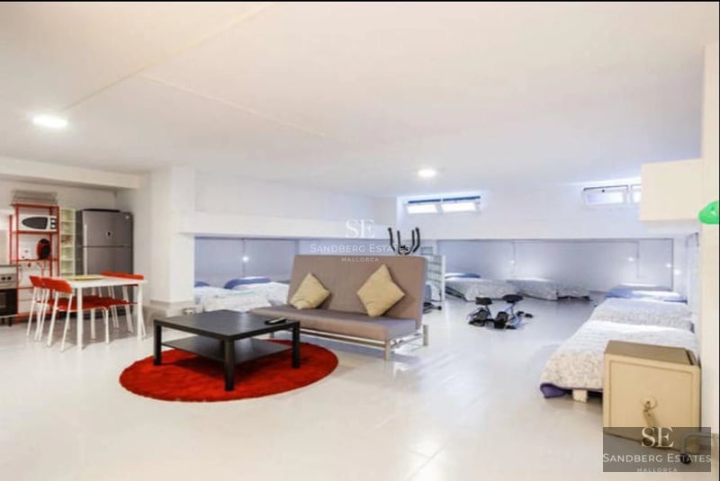 Spacious living room with panoramic windows, sea views, modern and elegant furniture, and abundant natural light.