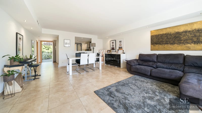 Exclusive Modern Villa with Pool, Prime Location View of a reflecting pool surrounded by lawn and a modern house with large windows and a glass balcony.