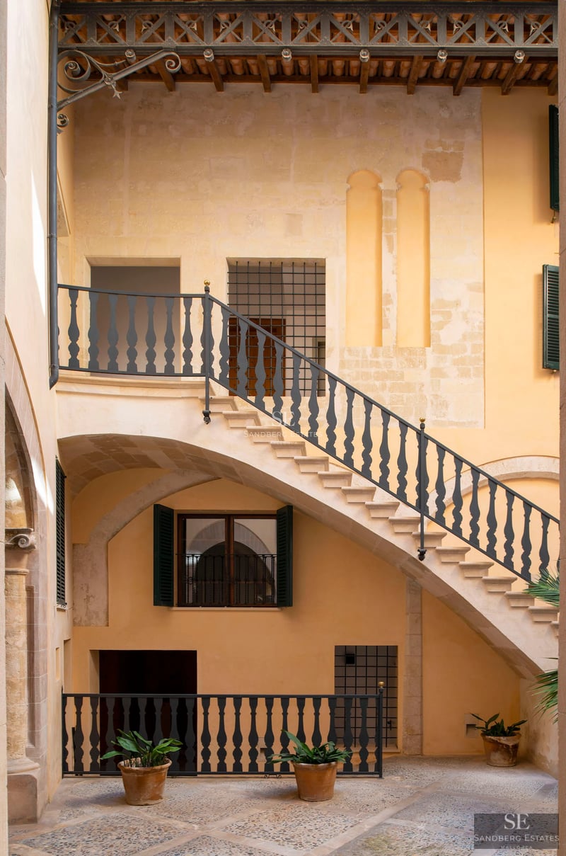 Spacious living room with modern fireplace, large windows, and designer furniture. Natural lighting and panoramic views. Elegance and comfort.