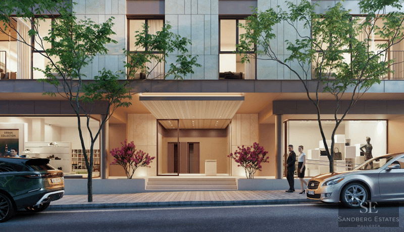 Ground floor of a modern building with central entrance, glass storefronts, sidewalk trees, and luxury cars.