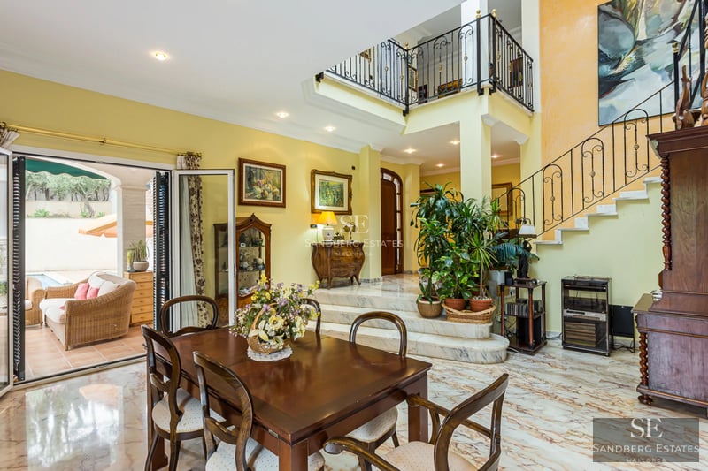 Exterior view of a modern villa featuring a pool, large garden, and minimalist architectural design. Warm lighting and sophisticated ambiance.