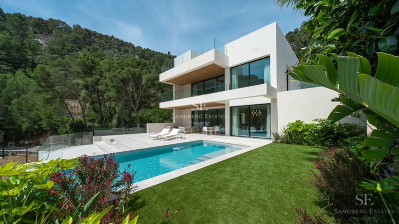Modern facade with reflective pool. Minimalist architecture, large windows, lush greenery, and clean lines.