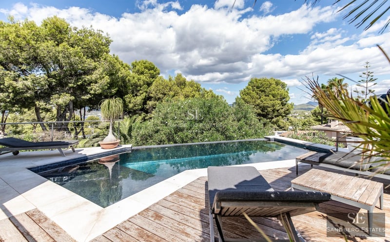 Spacious terrace with pool and panoramic views. Modern architecture, elegant furnishings, and abundant natural light.