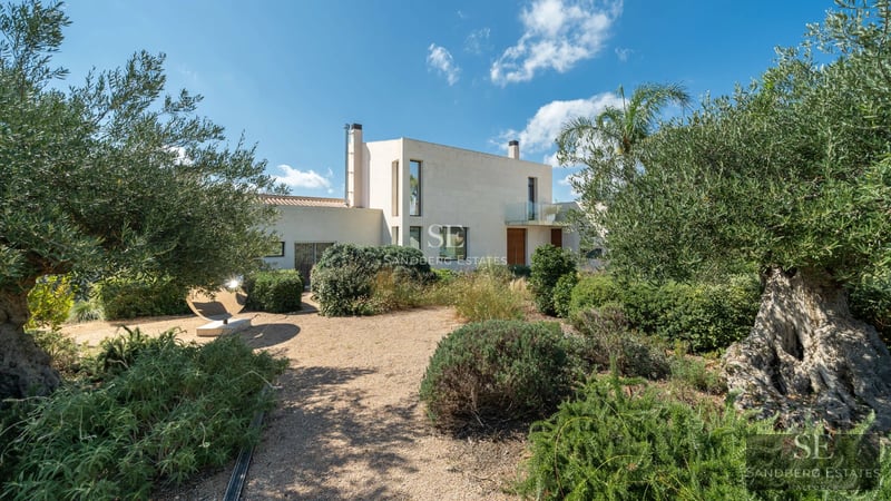 Spacious balcony with sea view, modern and elegant furniture. Wooden floors, glass railing, and comfortable seating area.