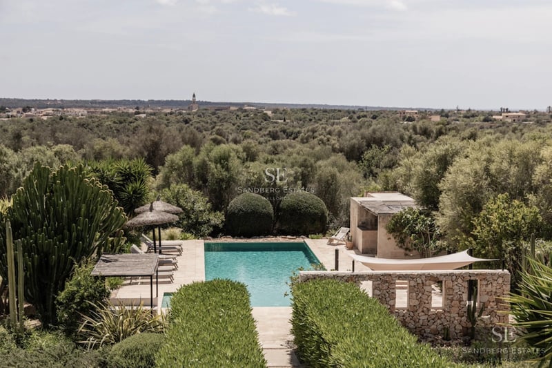 Image of a modern villa with a pool, large windows, and elegant landscaping. Minimalist design with natural touches.