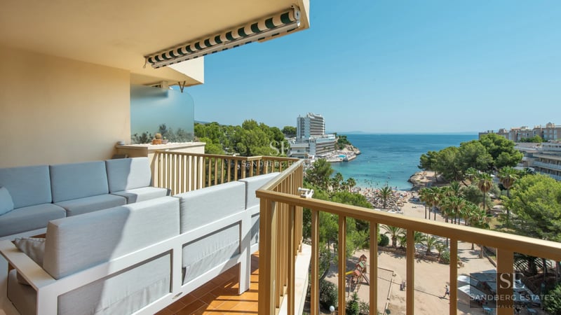 View of modern pool surrounded by vegetation. Minimalist architecture with large windows and manicured landscaping.
