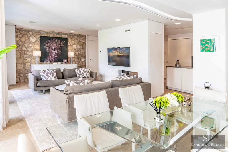 Exterior of a modern villa featuring an infinity pool, spacious terraces, and panoramic views. Minimalist design with high-quality finishes.