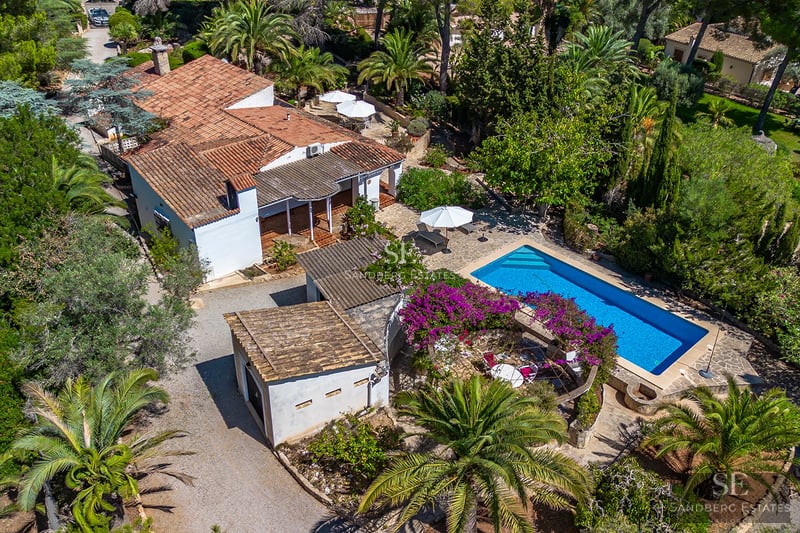 Exterior view of a modern villa with an infinity pool, large garden, and minimalist design. Warm ambient lighting.