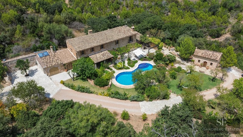 Exterior view of a modern villa with a pool, lush garden, and spacious terraces. Minimalist architecture with large windows.