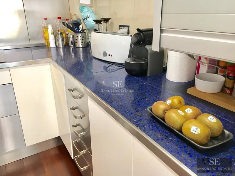 Modern terrace with pool, sun loungers, and panoramic sea views. Elegant furniture and minimalist design with spacious open areas.