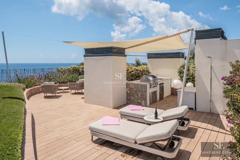 Exterior view of a modern villa with a pool, large garden, and minimalist architecture. Warm lighting highlights the facade.