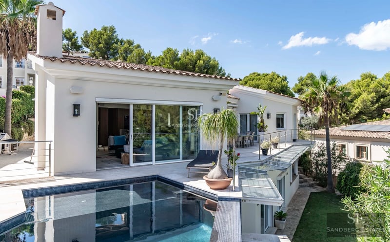 Exterior view of a modern villa with a pool. Minimalist architecture, large windows, reflective pool, lush garden. Ambient lighting.
