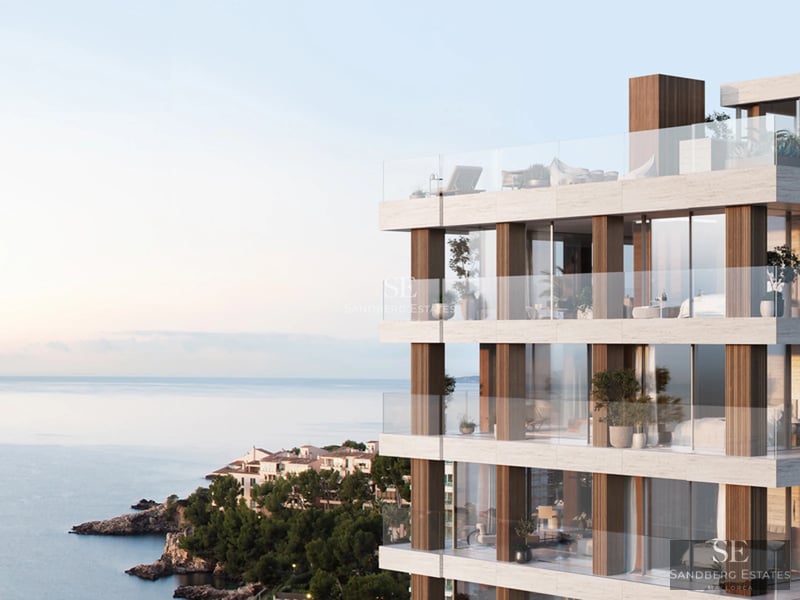 Exterior view of a modern villa with a pool. Features minimalist architecture, large windows, and lush landscaping.