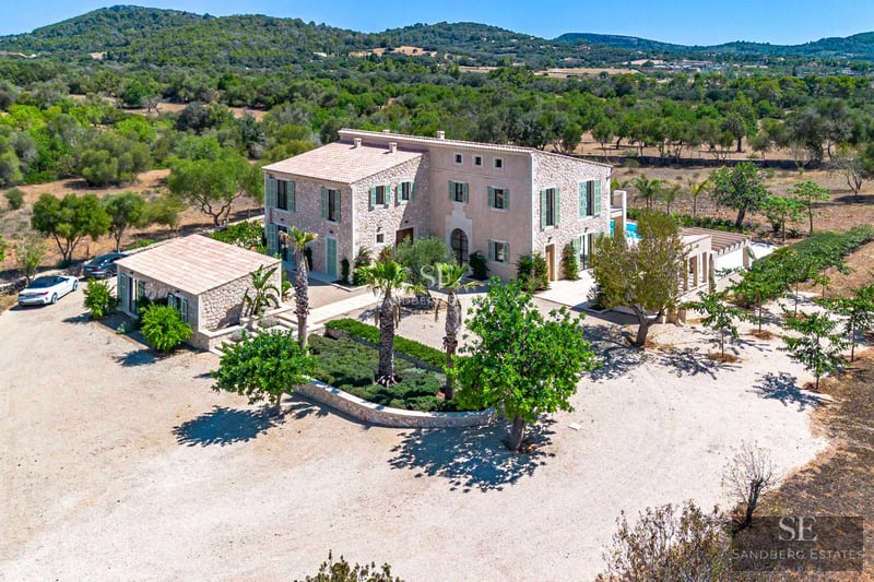 Terrace with panoramic sea views. Modern design, glass railing, elegant furniture and lush vegetation.