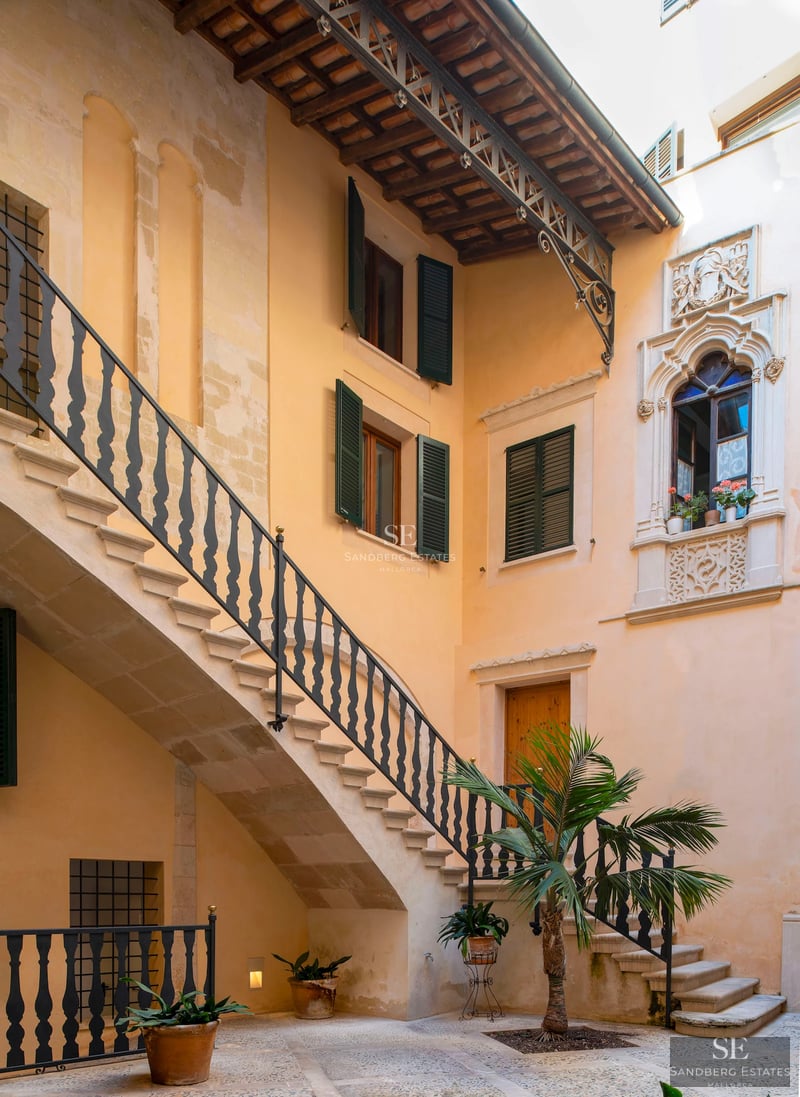 Spacious living room with large windows, light wood flooring, modern fireplace, and stunning sea views. Minimalist and elegant design.