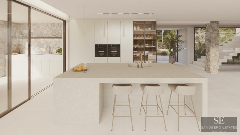A minimalist modern kitchen featuring a large stone central island, beige bar stools, and natural stone wall accents.