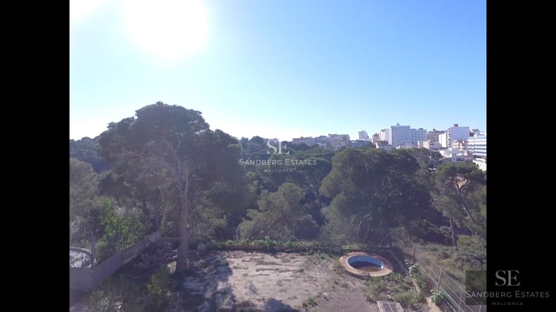 Exterior view of a modern villa with reflecting pool, expansive windows and minimalist landscaping. Soft ambient lighting.