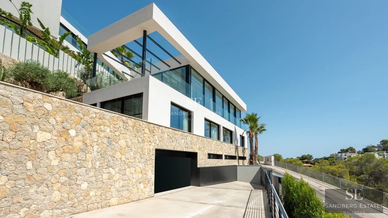 Spacious balcony with panoramic sea views. Modern design with glass railing and stylish outdoor furniture.