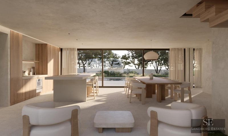 Amplio salón moderno de concepto abierto con cocina, comedor y grandes ventanales con vistas a una piscina y árboles.