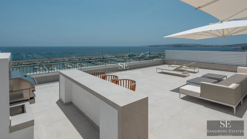 Panoramic view of modern villa featuring an infinity pool, expansive windows, terrace, and lush vegetation. Contemporary design and spectacular views.