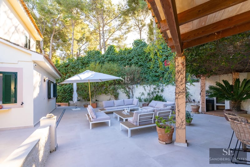 Spacious terrace with infinity pool, sun loungers, and panoramic views. Modern design, high-end finishes, and lush vegetation.