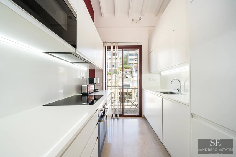 Exterior view of a modern house with an infinity pool, lush garden, and minimalist natural stone facade. Warm lighting.
