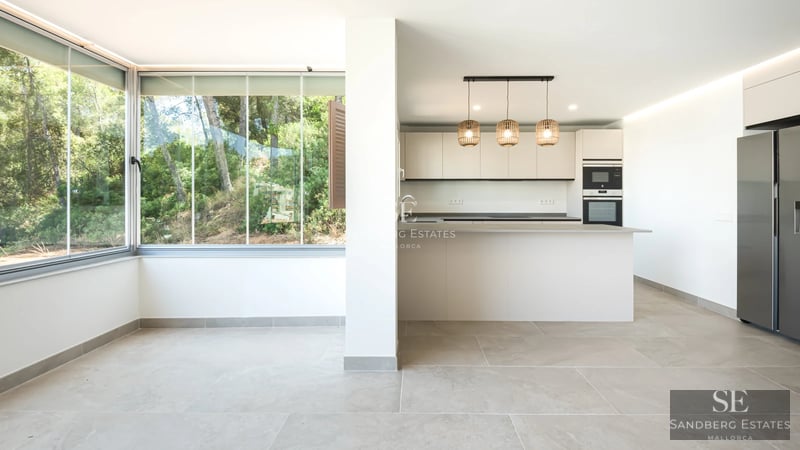 Spacious, bright living room with floor-to-ceiling windows, light wood floors, modern furniture & balcony access with view. Minimalist design.