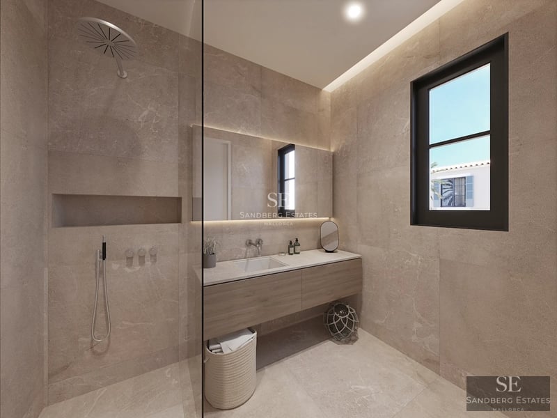 Exterior view of a modern house with pool, well-maintained garden and large windows reflecting sunlight.