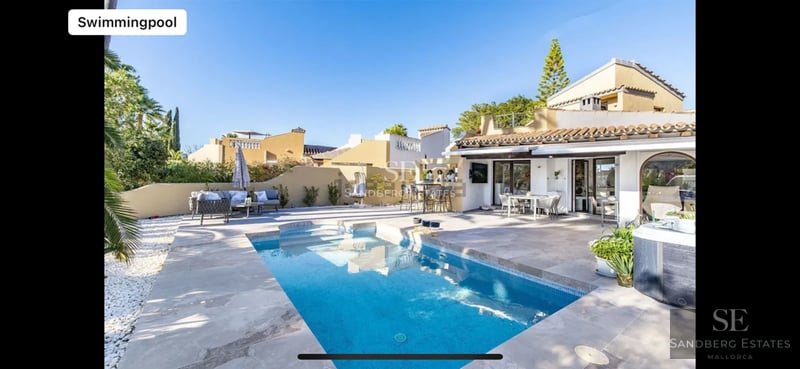 Spacious terrace with infinity pool, panoramic views, modern furniture, and lush vegetation. Contemporary architectural design.