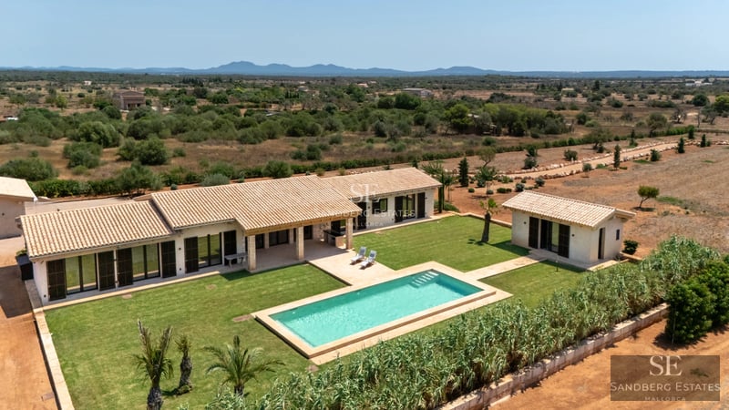 Spacious living room with panoramic windows, light wood floors, and modern decor. Stunning sea views.