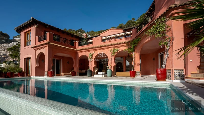 Spacious balcony with panoramic sea views. Sleek modern design featuring glass railings and minimalist outdoor furniture.