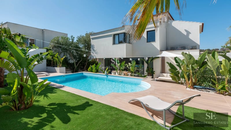 Exterior view of a modern villa with a pool. Sleek design, large windows, and landscaped surroundings. Ideal for investment.