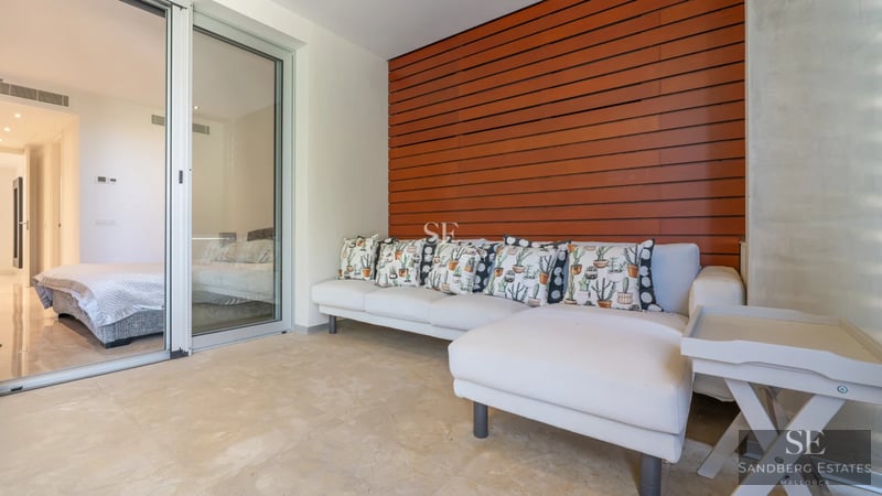 Expansive terrace with infinity pool. Modern design featuring sleek outdoor furniture and panoramic sea views. Luxury and comfort.