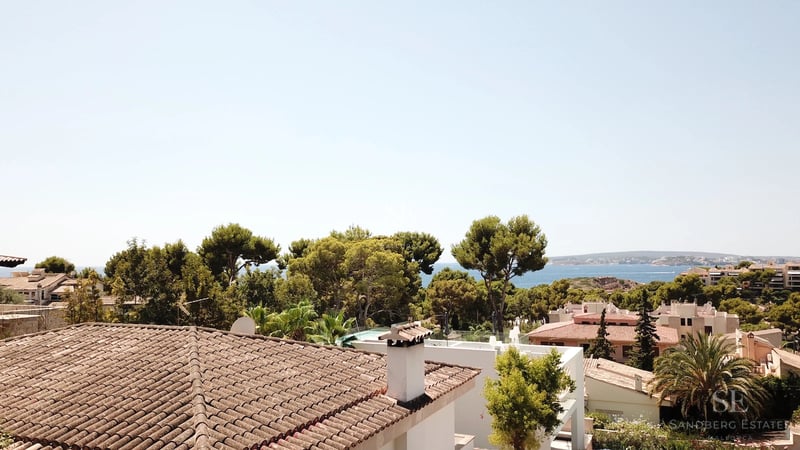 Spacious terrace with sea view. Modern design, elegant outdoor furniture, and infinity pool.