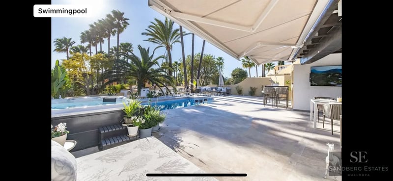 Modern villa with minimalist facade, reflecting pool, large windows, and lush vegetation. Elegant and contemporary architectural design.