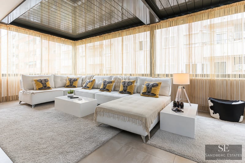 Spacious terrace with pool and sea views. Modern design with sun loungers, umbrellas, and lush vegetation. Ideal for relaxation.