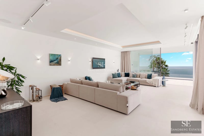 Exterior view of modern villa with pool, landscaped garden, and minimalist architecture. Large windows reflect natural light.