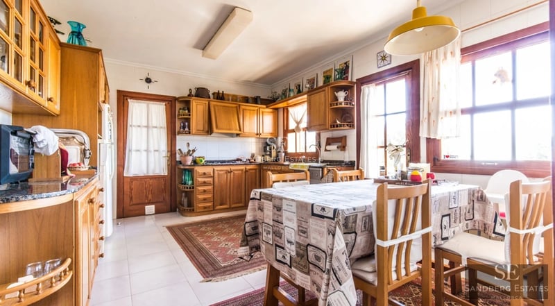 Spacious living room with panoramic windows, modern fireplace, and access to a view terrace. Bright and stylish interior design.
