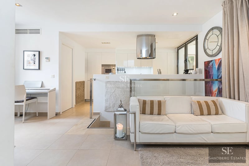 Expansive pool terrace surrounded by gardens. Modern architecture with large windows and luxury finishes.