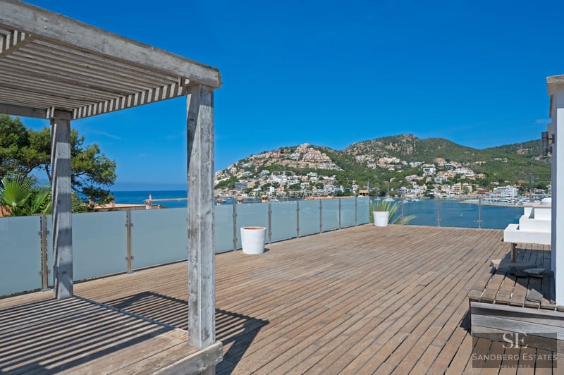 Exterior view of a modern home with a pool. Minimalist architecture, large windows, and lush natural surroundings.