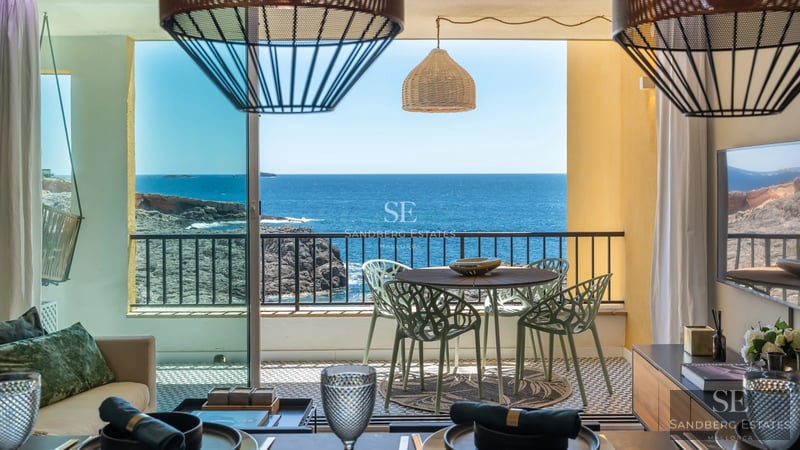 View of a modern pool with sleek design and lounge area. Well-maintained garden in the background. Ideal for relaxation and recreation.