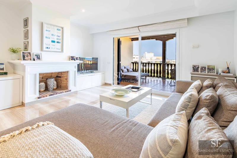 Panoramic view from modern penthouse with balcony, infinity pool and stunning Mediterranean Sea views. Sleek design with natural light.